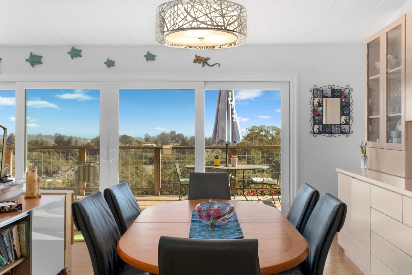 490 Amigo Road Soquel, CA 95073 - Photo 8 of 71 a view of a dining room with furniture large windows and a chandelier