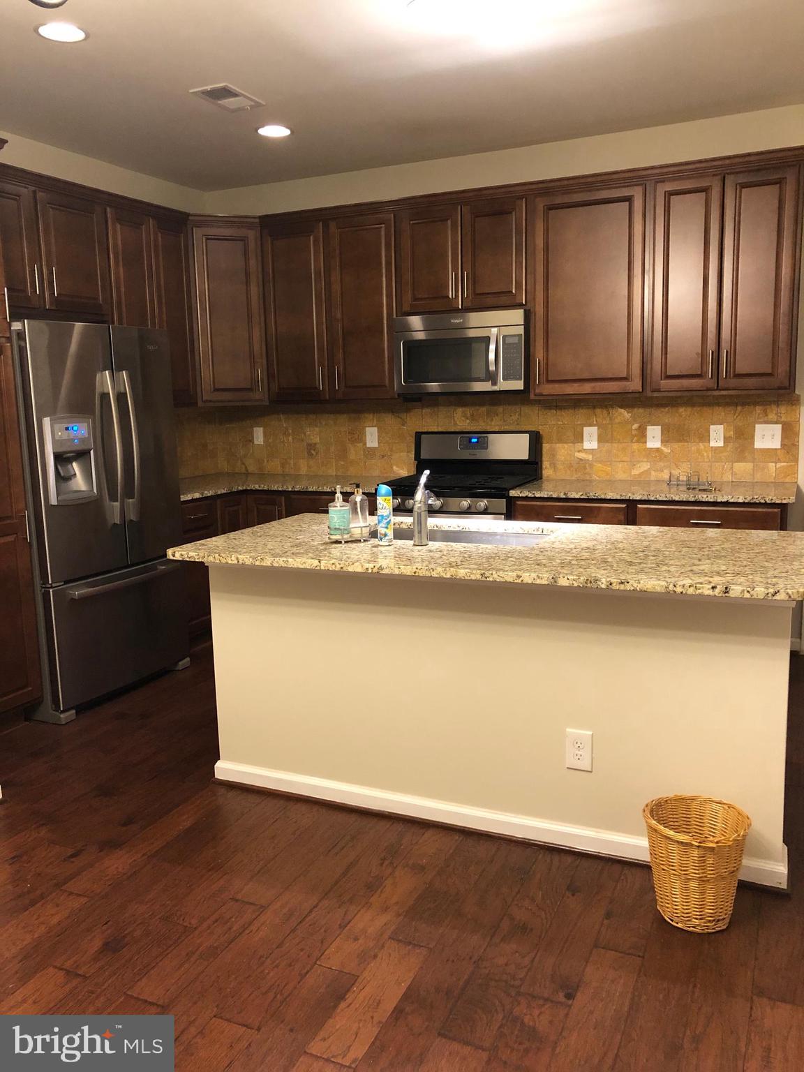 42797 Burrell Square Ashburn, VA 20147 - Photo 4 of 13 a kitchen with stainless steel appliances granite countertop a refrigerator microwave and stove