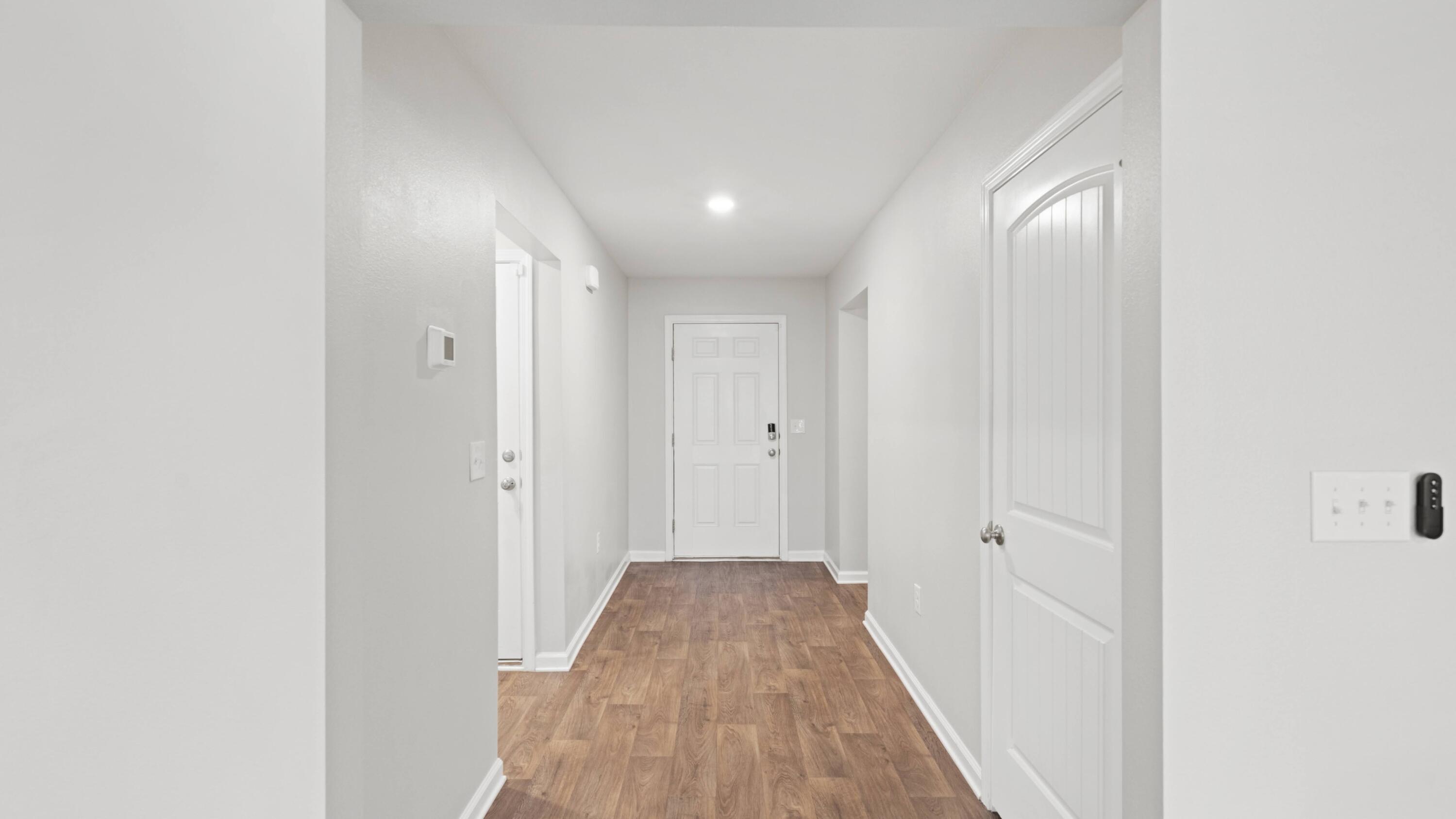 3927 Alva Thomas Road Panama City, FL 32404 - Photo 25 of 46 a view of a hallway with wooden floor