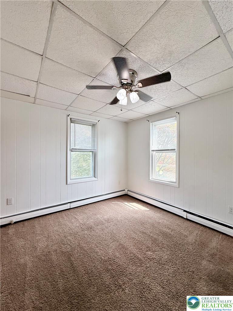5540 Main Street Whitehall, PA 18052 - Photo 26 of 53 A well-lit bedroom features plush carpeting and efficient ceiling ventilation.