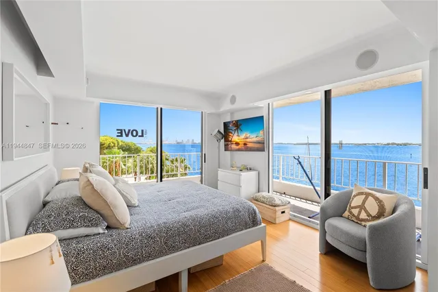a bedroom with furniture and a flat screen tv