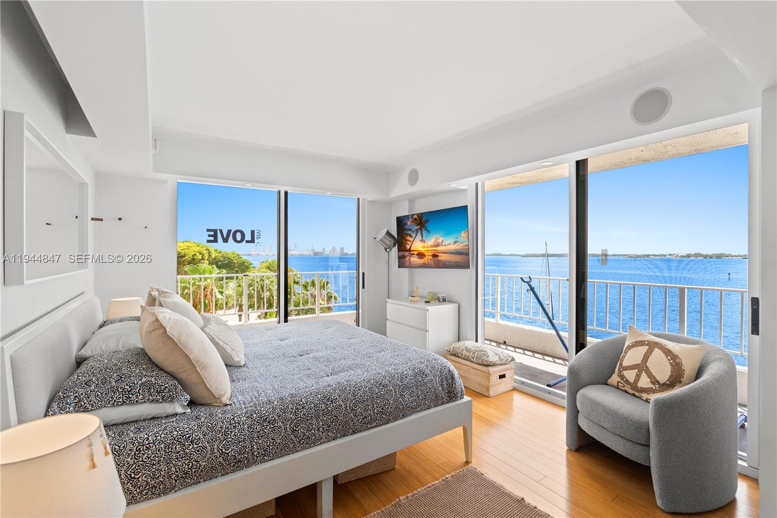 a bedroom with furniture and a flat screen tv