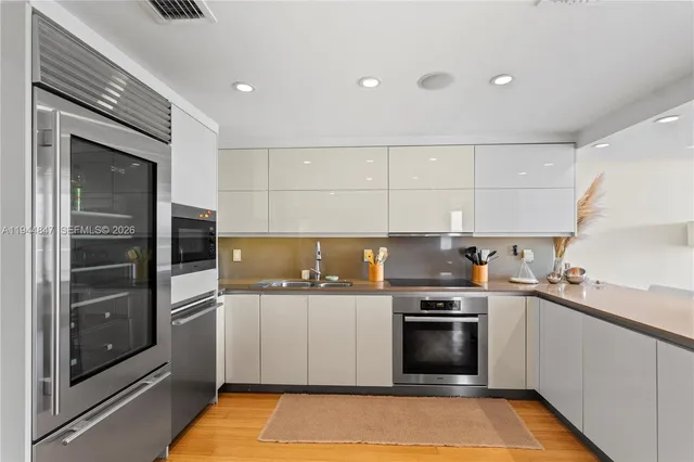 a kitchen with a sink stove and refrigerator