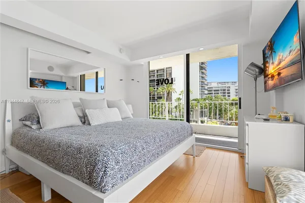 a bedroom with a large bed and a large window