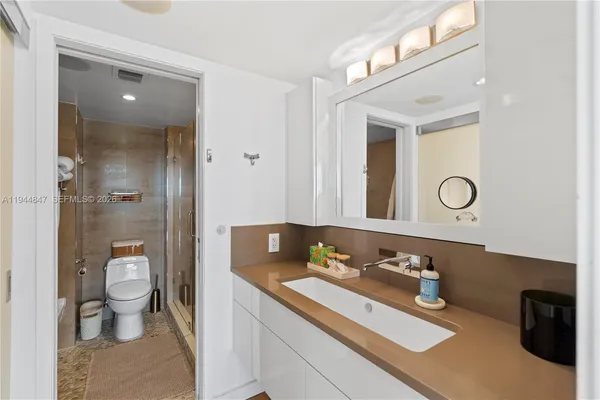 a bathroom with a sink toilet and shower