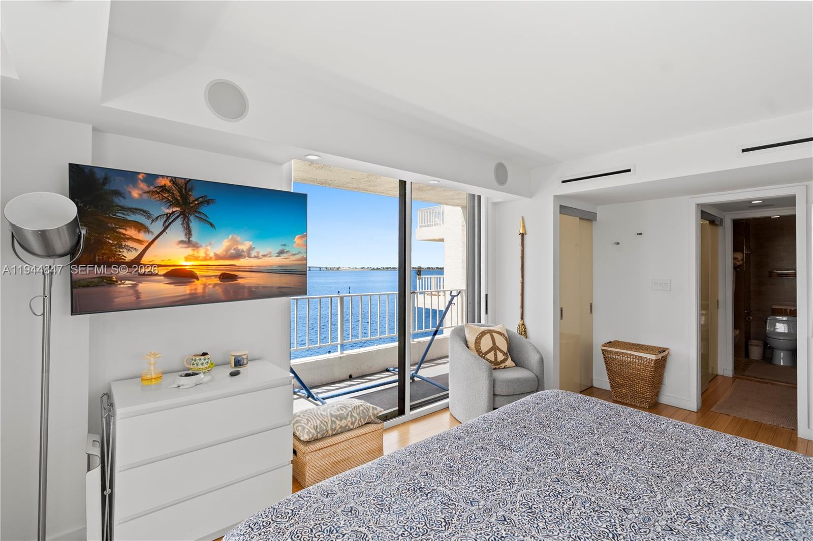 200 Southeast 15th Road, Unit 5D Miami, FL 33129 - Photo 2 of 25 a bedroom with a bed and wooden floor