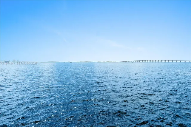 a view of ocean with green space