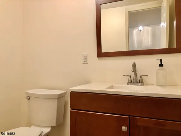 a bathroom with a sink a toilet and mirror