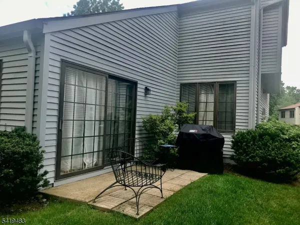 a view of house with backyard and outdoor seating