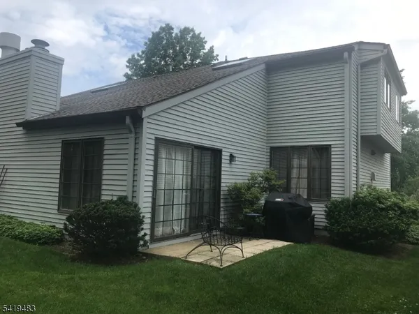 a front view of a house with a garden and yard