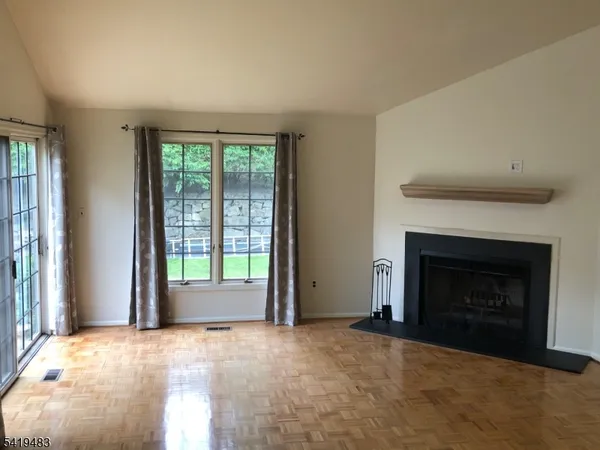 a view of empty room with a fireplace