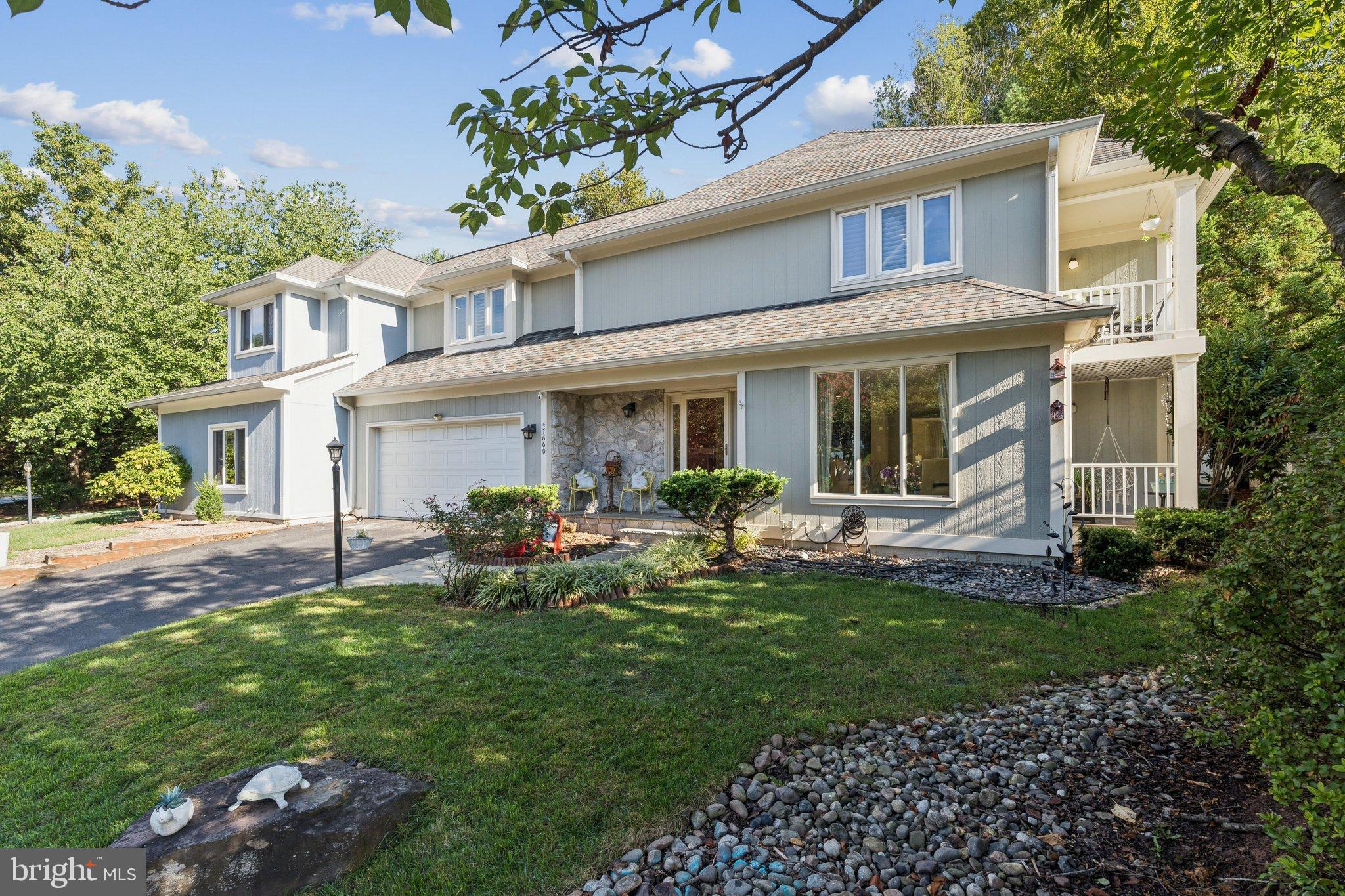 a front view of a house with a garden and porch