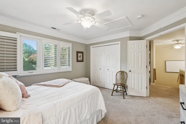 a spacious bedroom with a bed and large windows