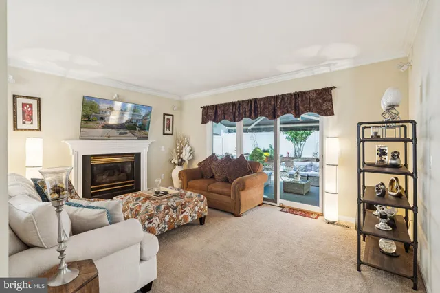 a kitchen with stainless steel appliances kitchen island granite countertop a stove a sink and white cabinets with wooden floor