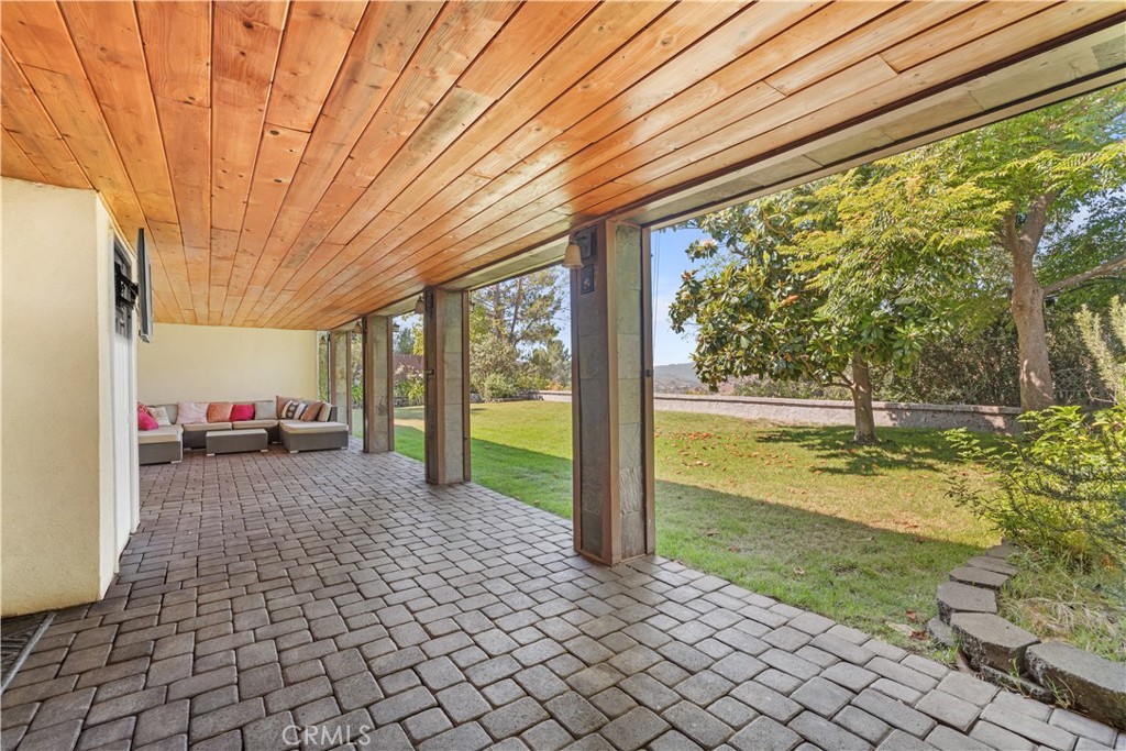 26096 Adamor Road Calabasas, CA 91302 - Photo 54 of 61 Large covered patio with wood ceiling, slate columns, built in lighting and speakers.