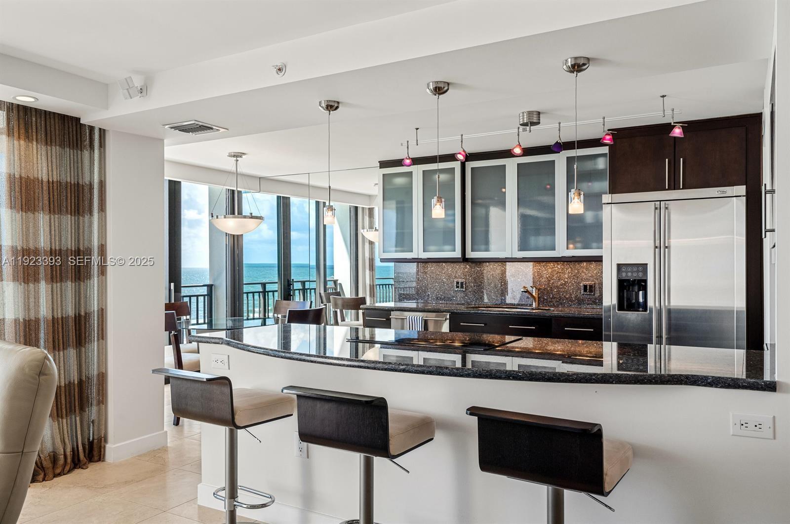 1800 South Ocean Boulevard, Unit 5C Boca Raton, FL 33432 - Photo 12 of 98 a kitchen with stainless steel appliances granite countertop a stove a sink and a refrigerator