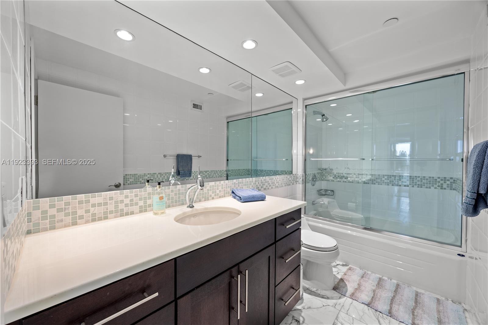 1800 South Ocean Boulevard, Unit 5C Boca Raton, FL 33432 - Photo 20 of 98 a bathroom with a sink a toilet and shower