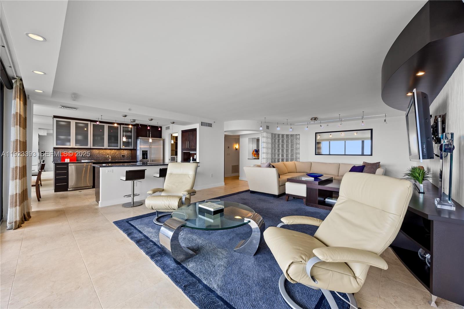 1800 South Ocean Boulevard, Unit 5C Boca Raton, FL 33432 - Photo 24 of 98 a living room with furniture and a flat screen tv