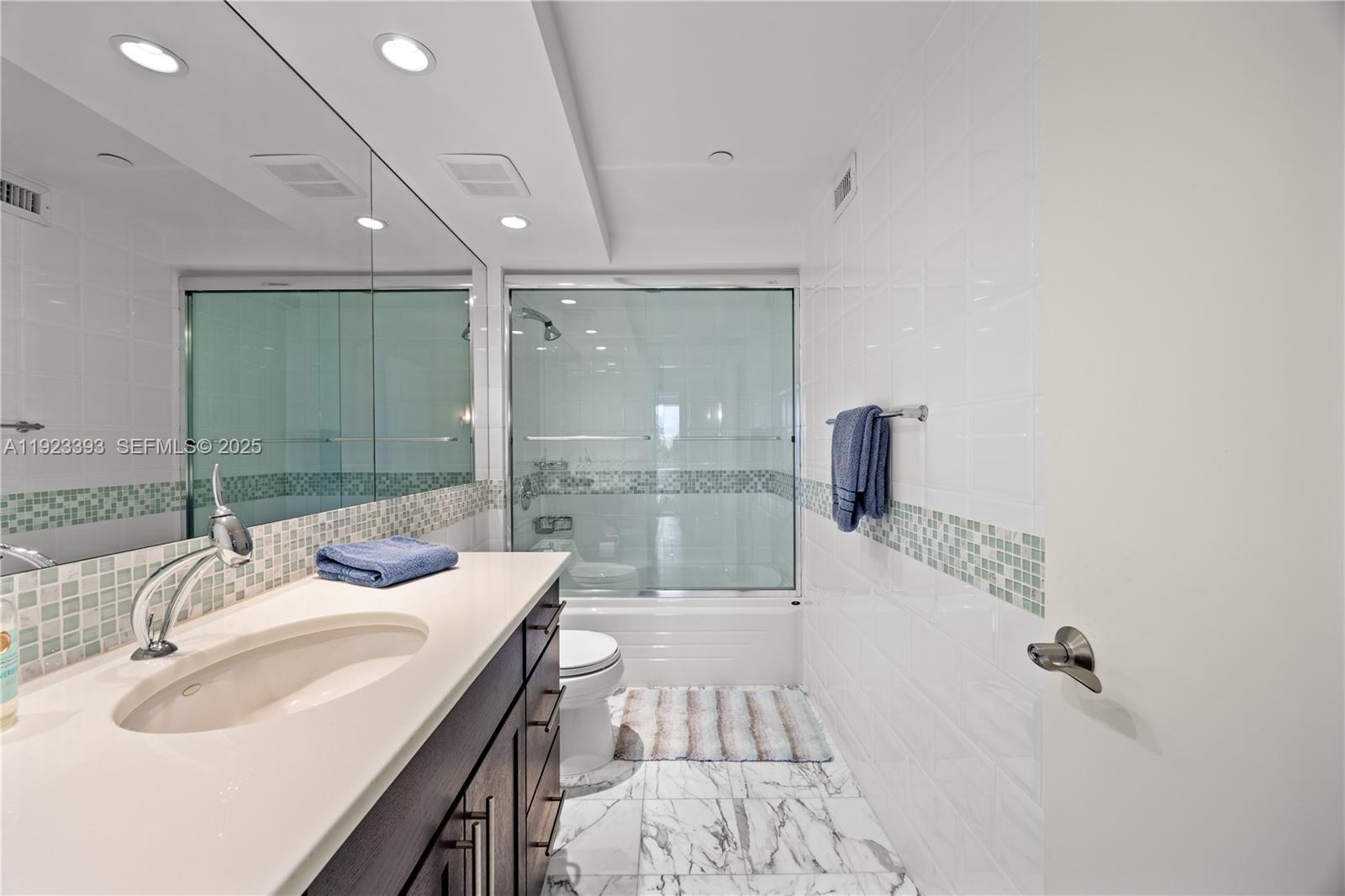 1800 South Ocean Boulevard, Unit 5C Boca Raton, FL 33432 - Photo 25 of 98 a bathroom with a sink and a mirror