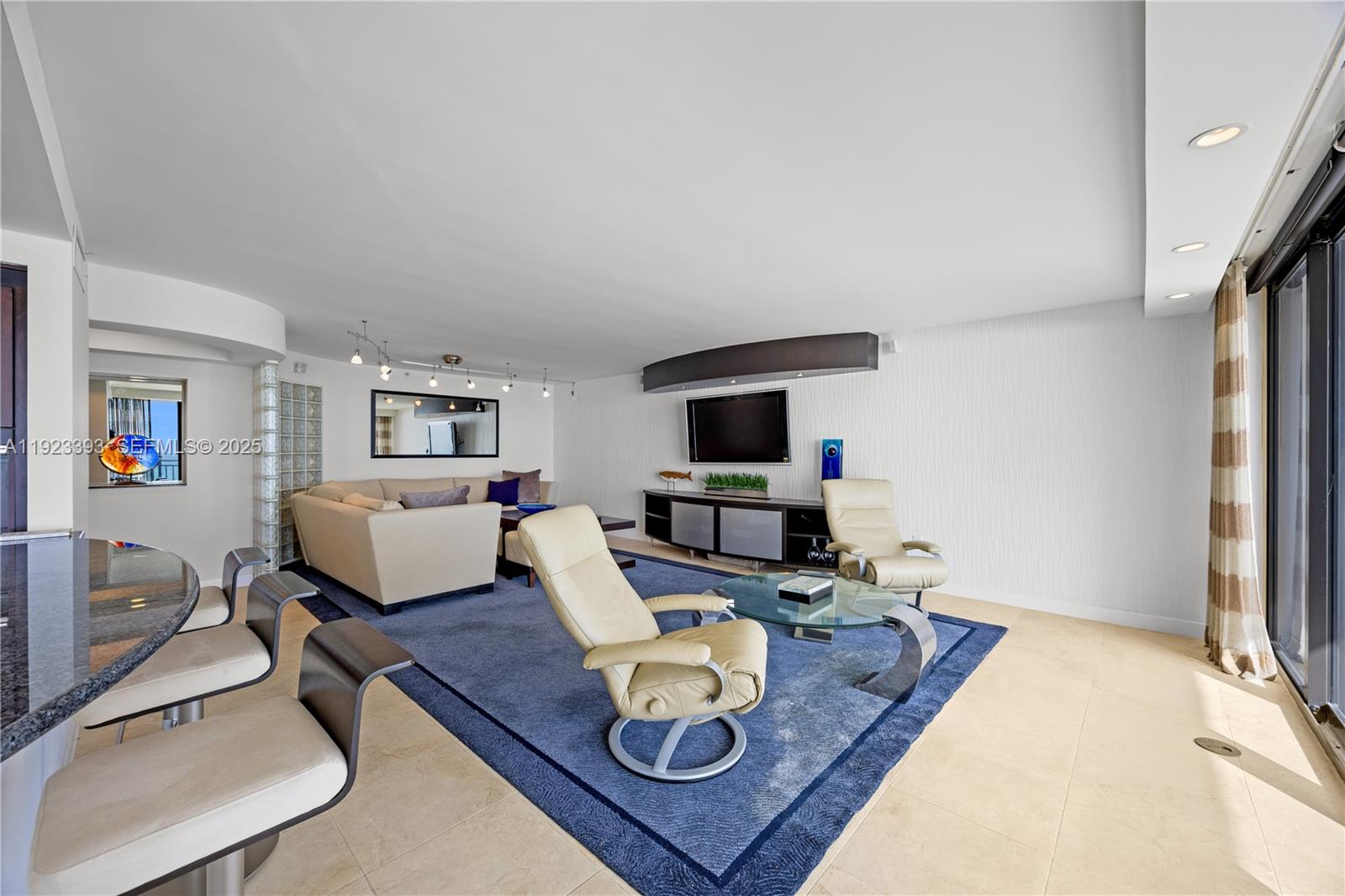 1800 South Ocean Boulevard, Unit 5C Boca Raton, FL 33432 - Photo 33 of 98 a living room with furniture and a flat screen tv