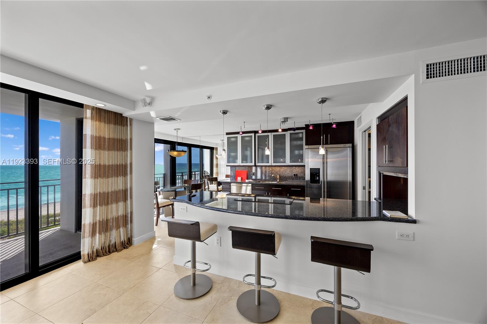 1800 South Ocean Boulevard, Unit 5C Boca Raton, FL 33432 - Photo 35 of 98 a kitchen with stainless steel appliances kitchen island granite countertop a refrigerator and cabinets