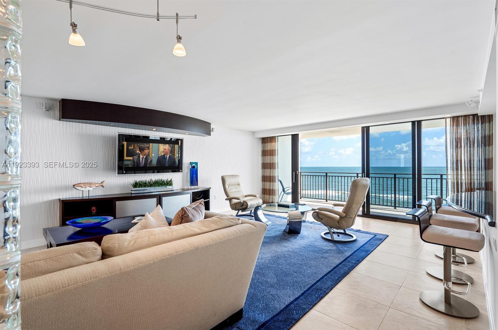 1800 South Ocean Boulevard, Unit 5C Boca Raton, FL 33432 - Photo 5 of 98 a living room with furniture and a flat screen tv