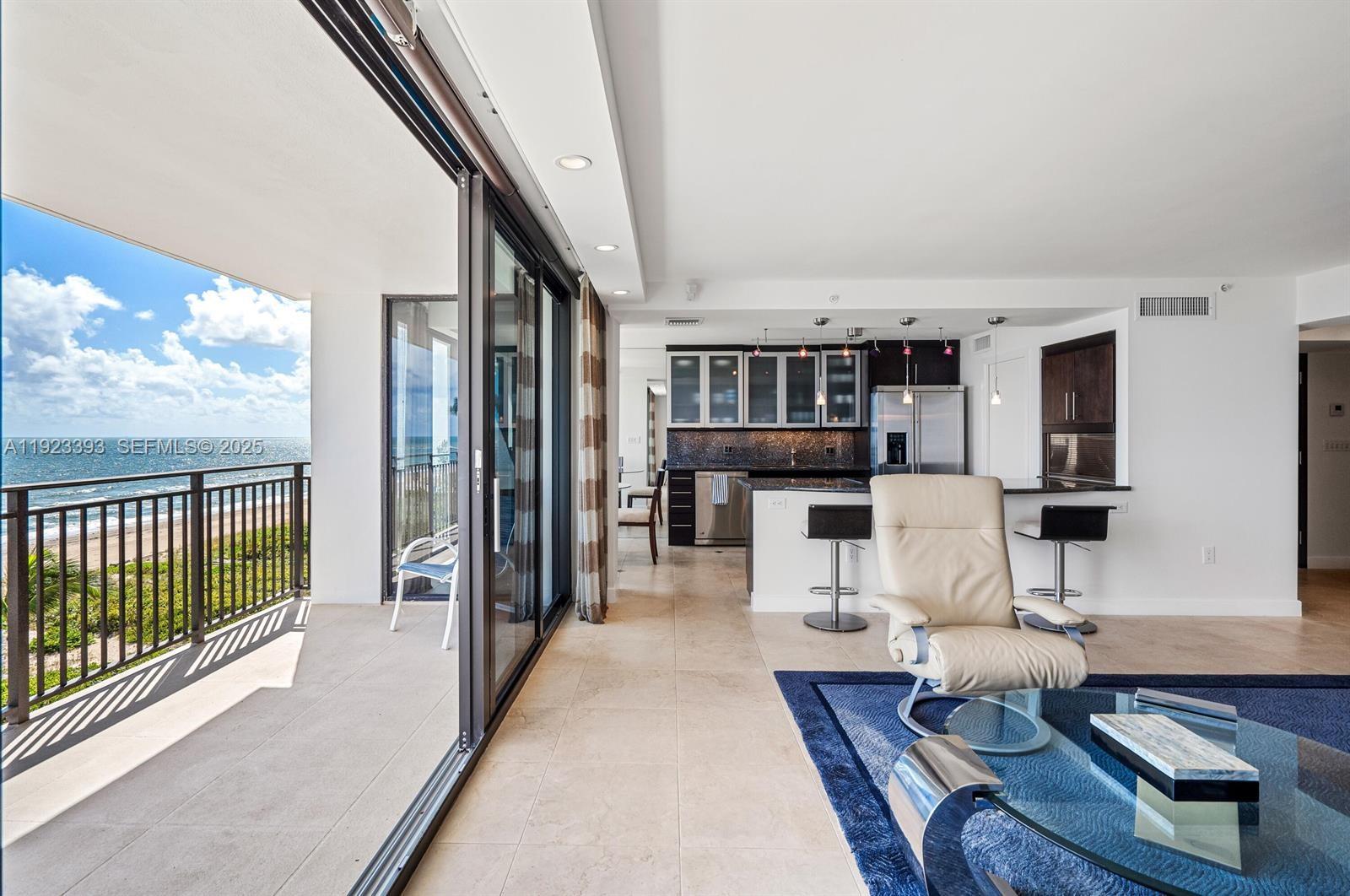 1800 South Ocean Boulevard, Unit 5C Boca Raton, FL 33432 - Photo 6 of 98 a living room with furniture a rug and a large window