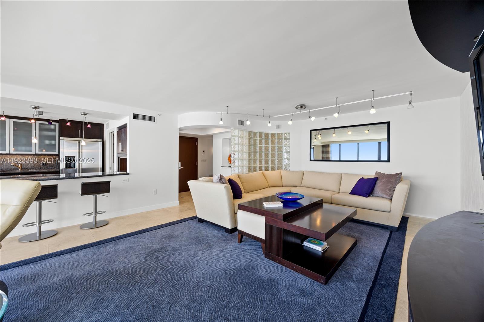 1800 South Ocean Boulevard, Unit 5C Boca Raton, FL 33432 - Photo 66 of 98 a living room with furniture and a flat screen tv