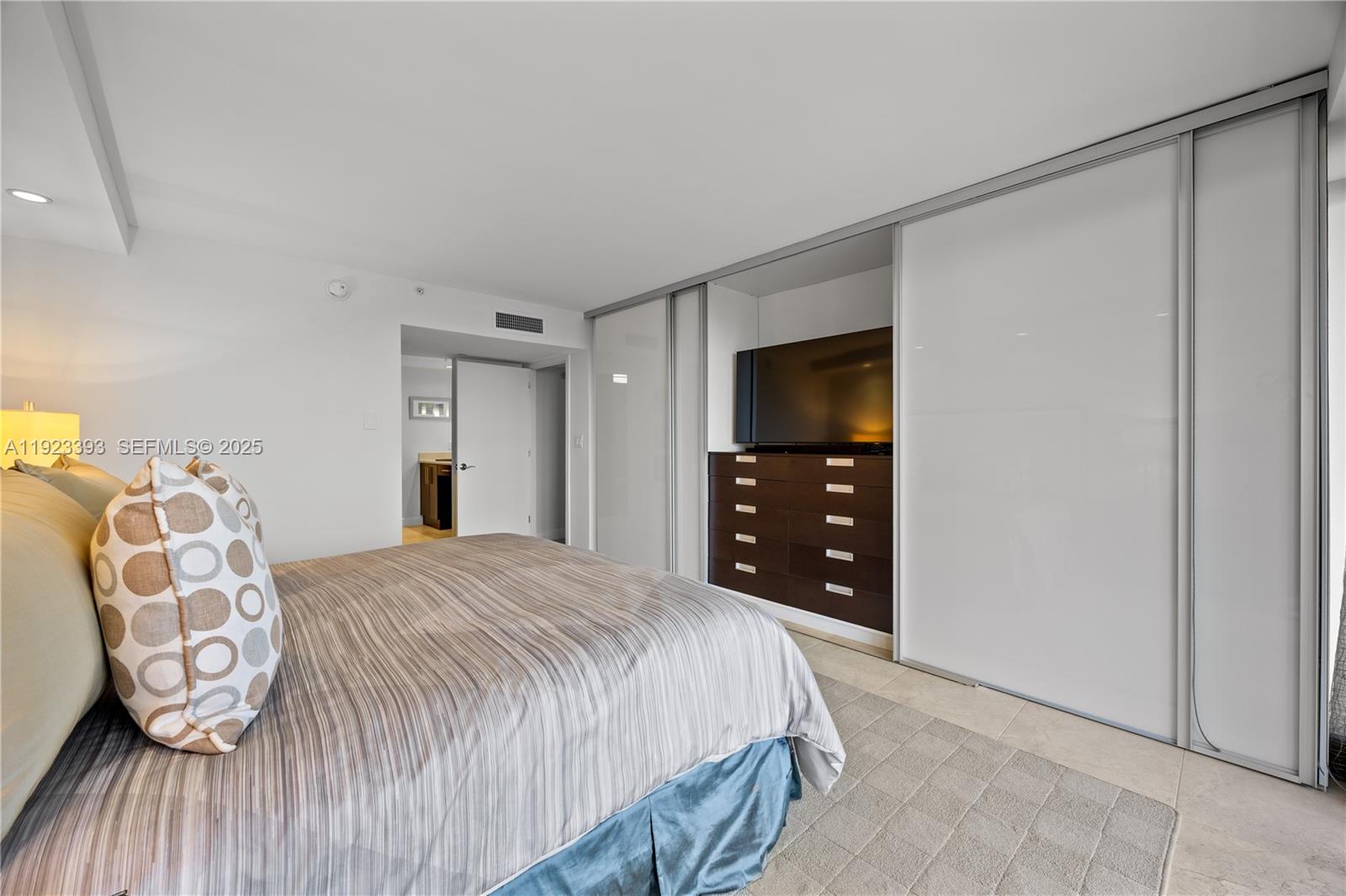 1800 South Ocean Boulevard, Unit 5C Boca Raton, FL 33432 - Photo 73 of 98 a bedroom with a bed a table and chair