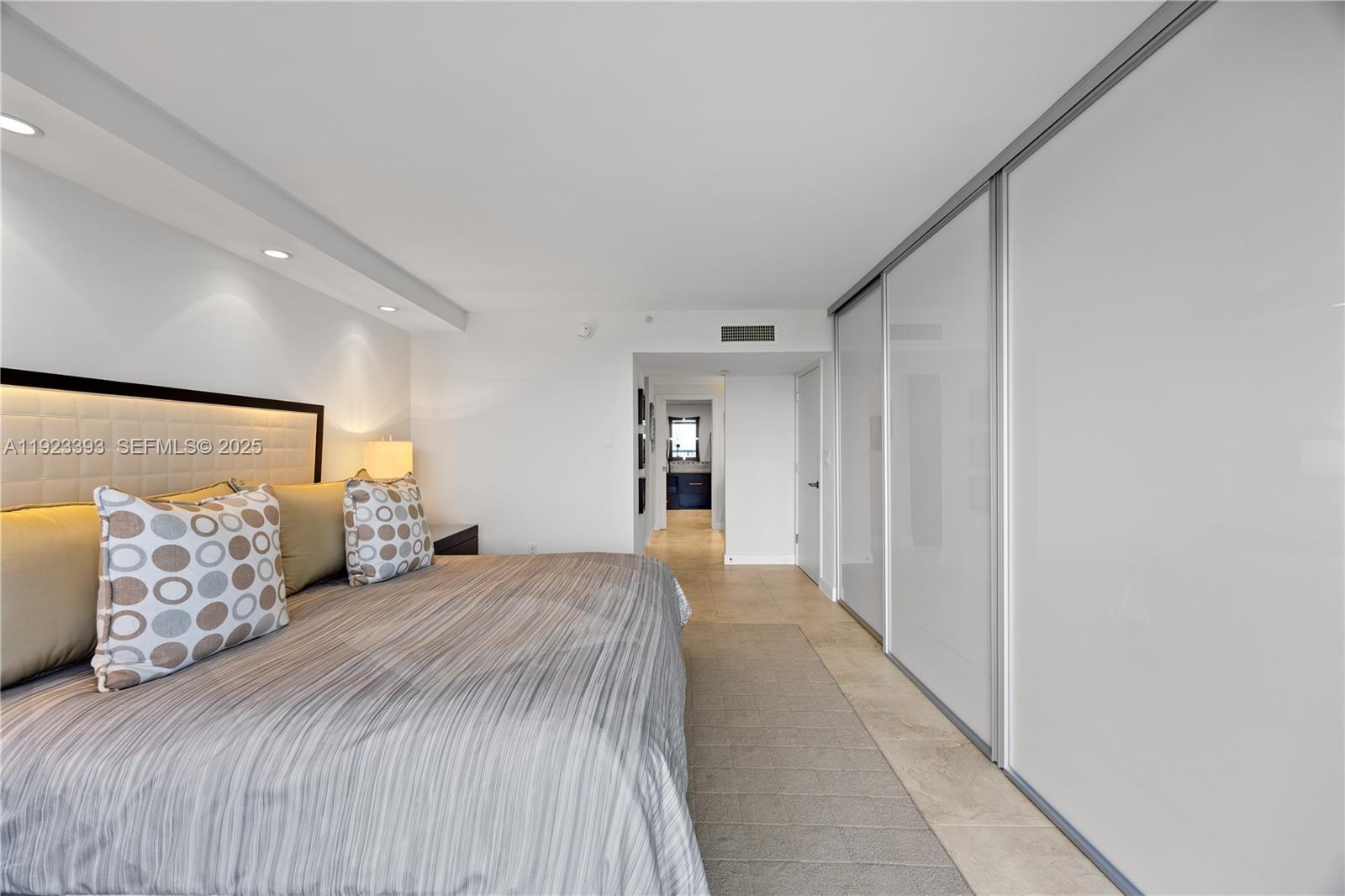 1800 South Ocean Boulevard, Unit 5C Boca Raton, FL 33432 - Photo 75 of 98 a bedroom with a large bed and a walk in closet
