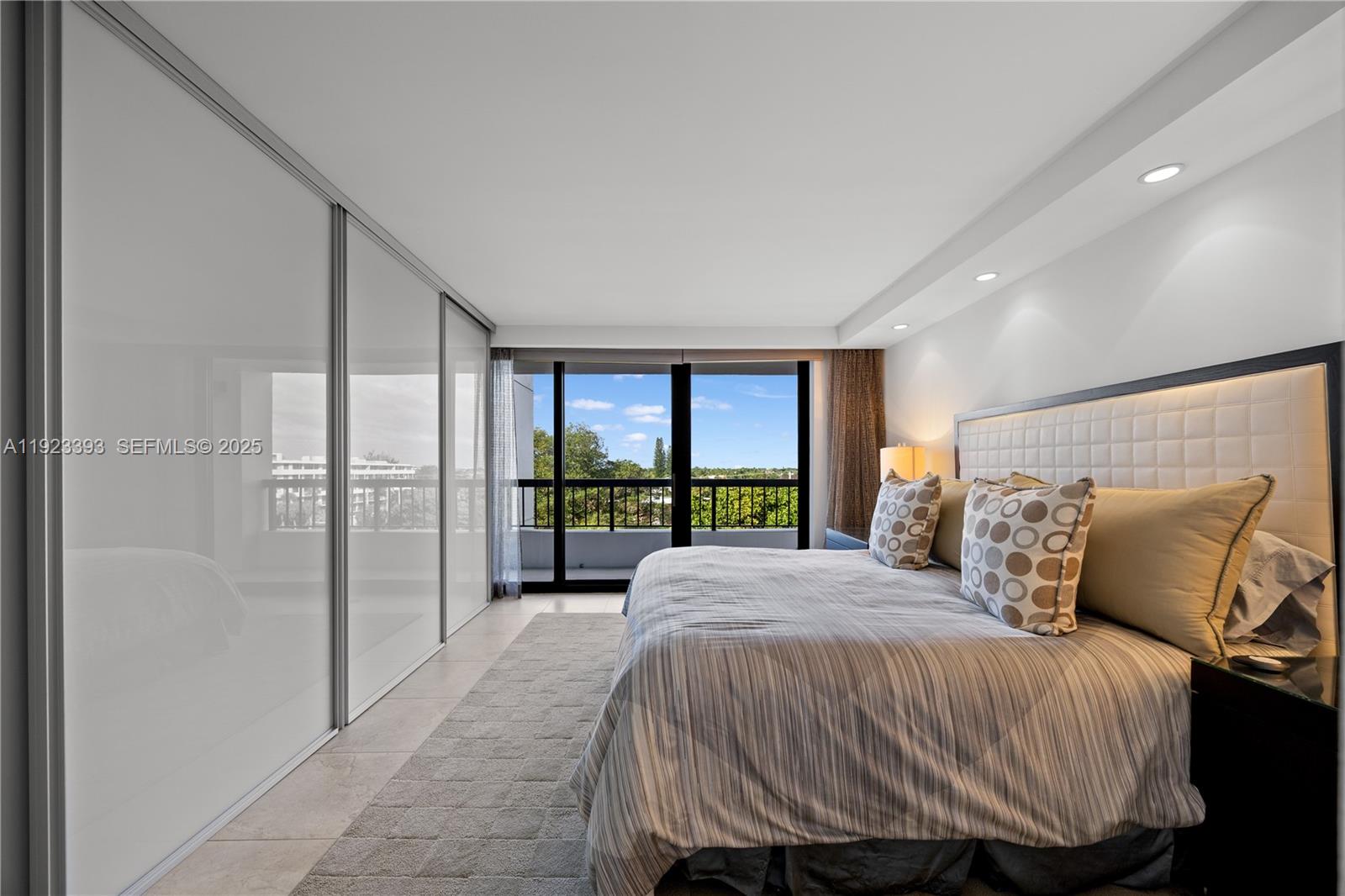 1800 South Ocean Boulevard, Unit 5C Boca Raton, FL 33432 - Photo 76 of 98 a bed sitting in a bedroom next to a balcony