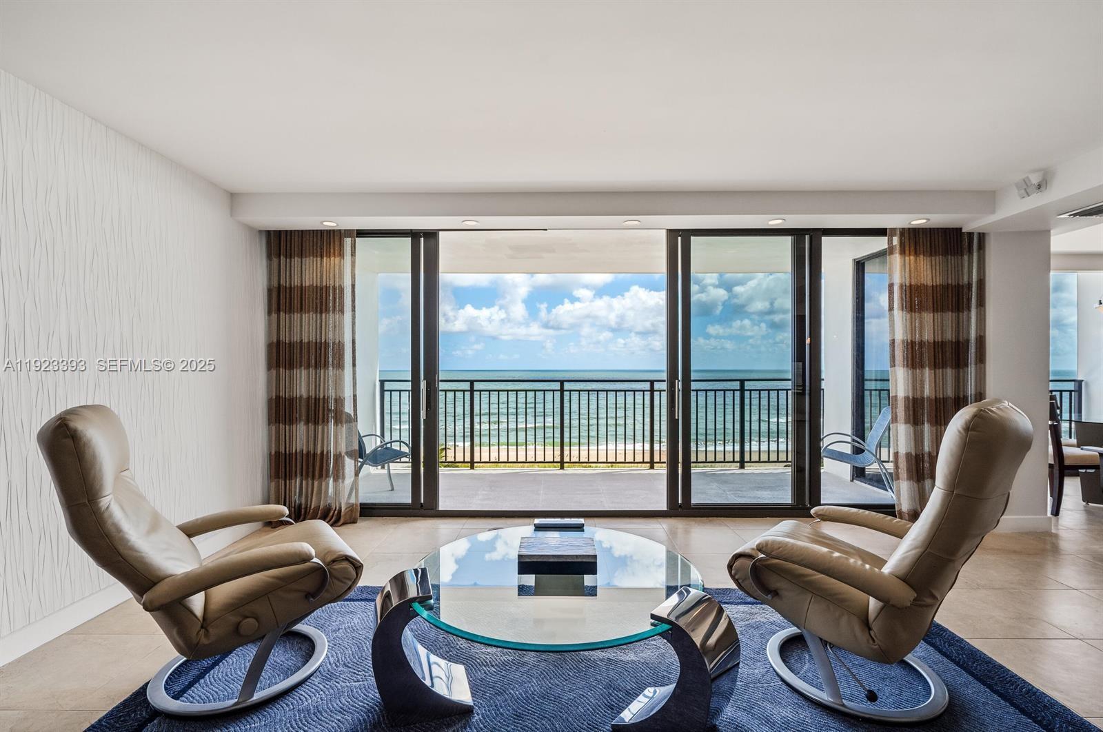1800 South Ocean Boulevard, Unit 5C Boca Raton, FL 33432 - Photo 9 of 98 a living room with furniture and a floor to ceiling window