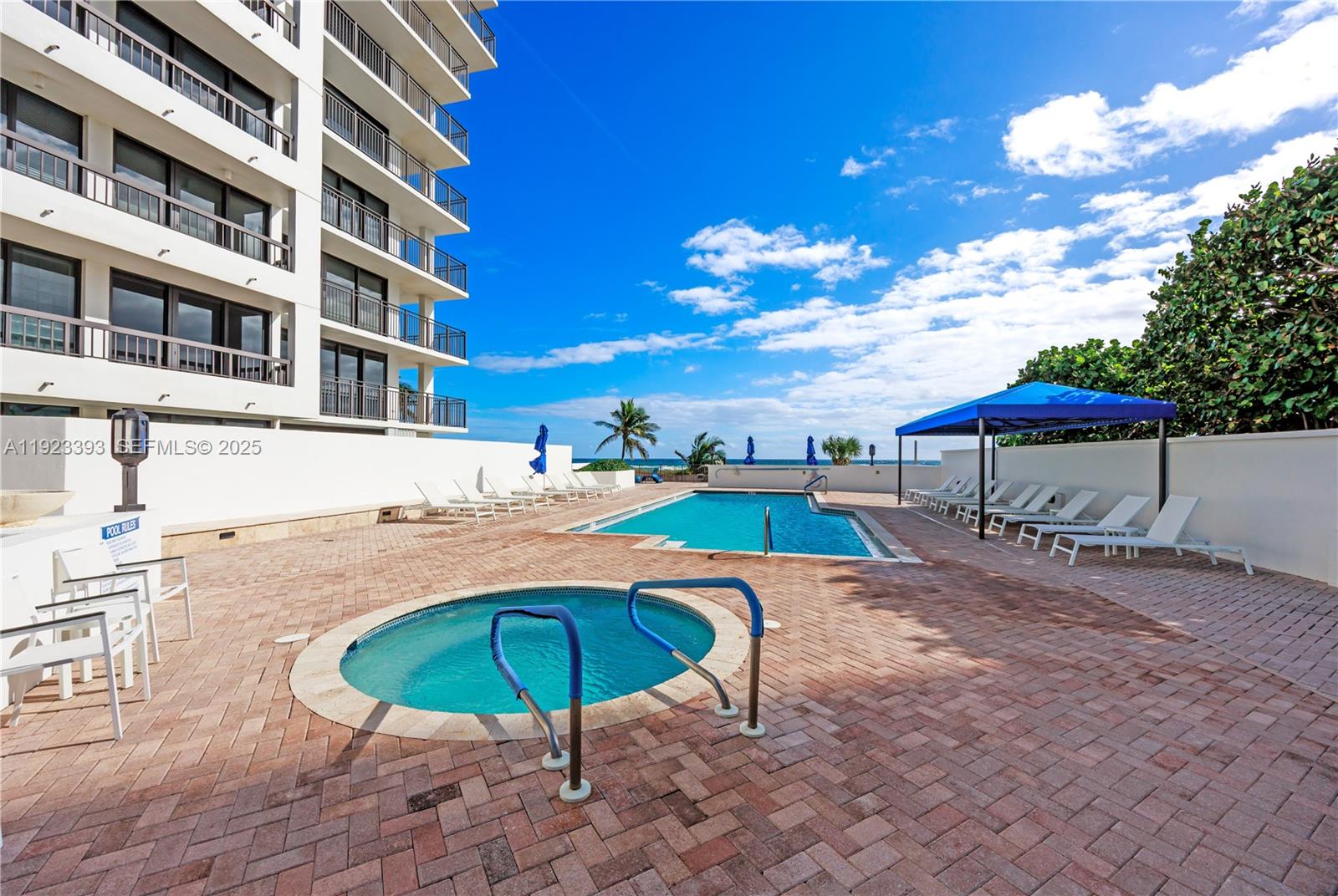 1800 South Ocean Boulevard, Unit 5C Boca Raton, FL 33432 - Photo 96 of 98 a view of a swimming pool with a lounge chairs