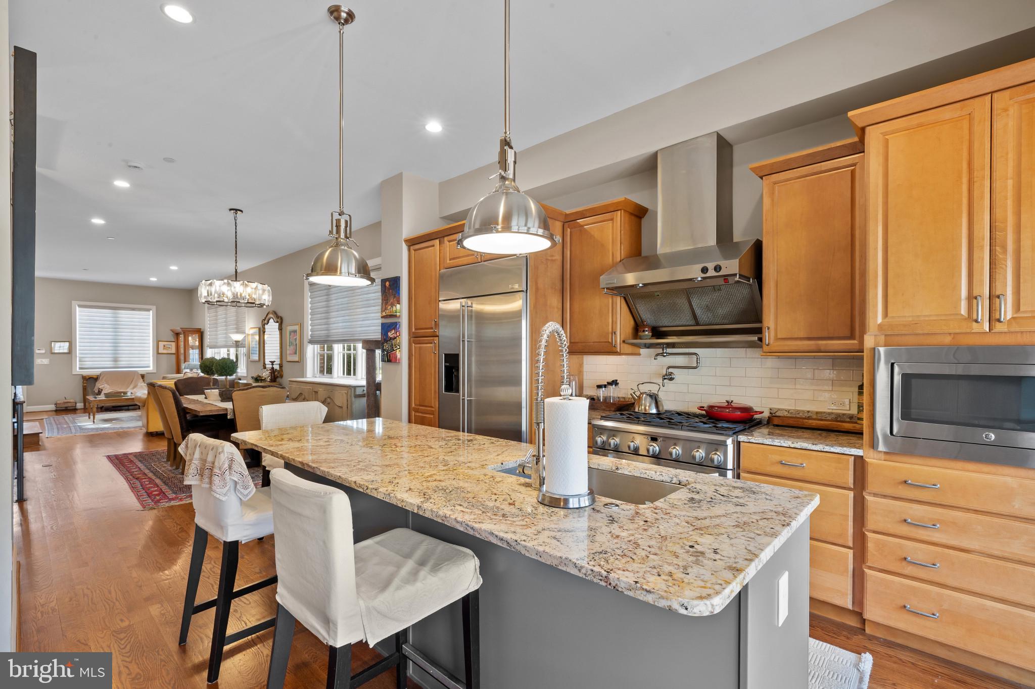 3800 Dillon Street Baltimore, MD 21224 - Photo 11 of 34 a kitchen with stainless steel appliances granite countertop a kitchen island a stove and a sink