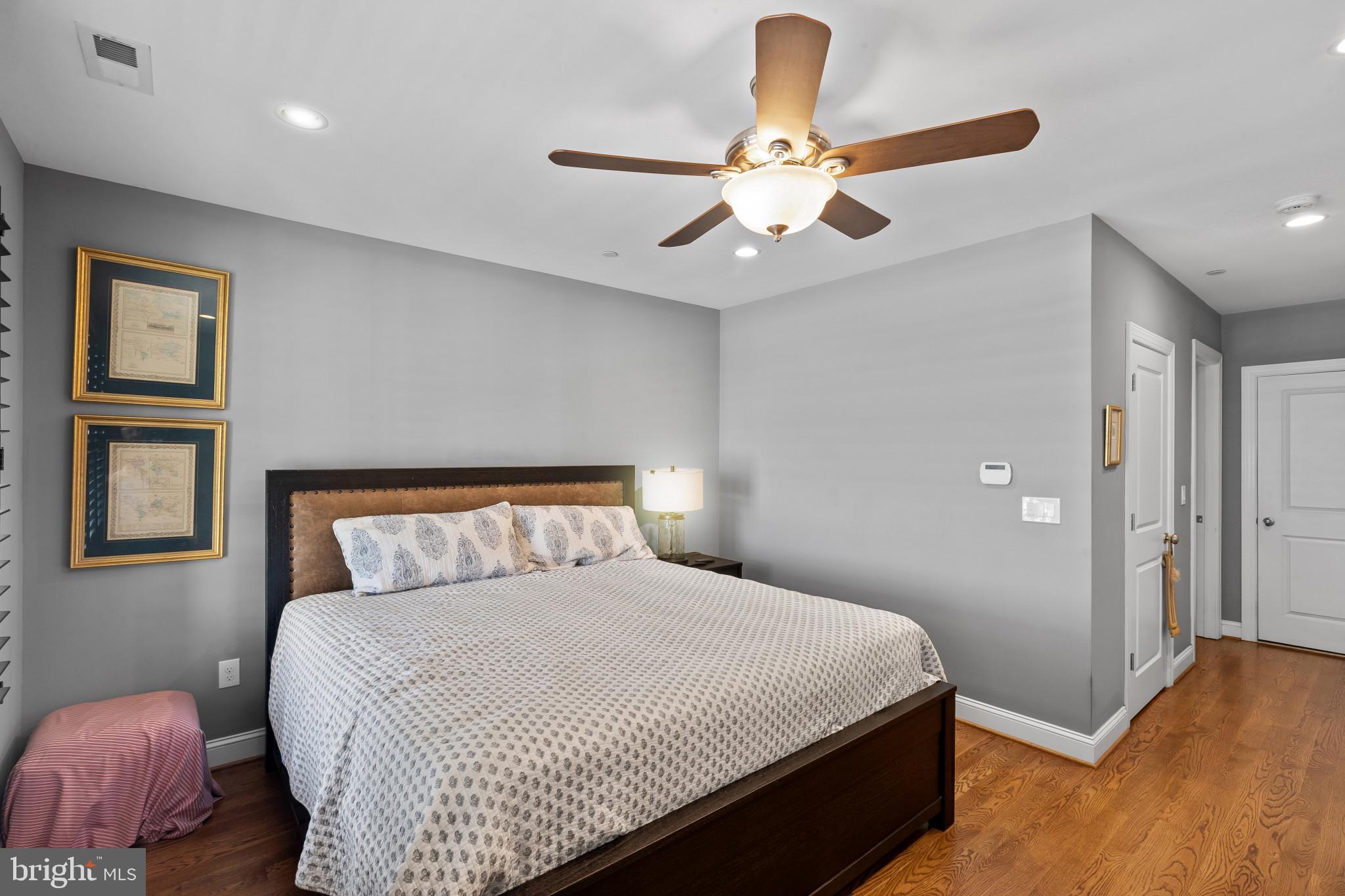 3800 Dillon Street Baltimore, MD 21224 - Photo 14 of 34 a bedroom with a large bed chandelier and a window