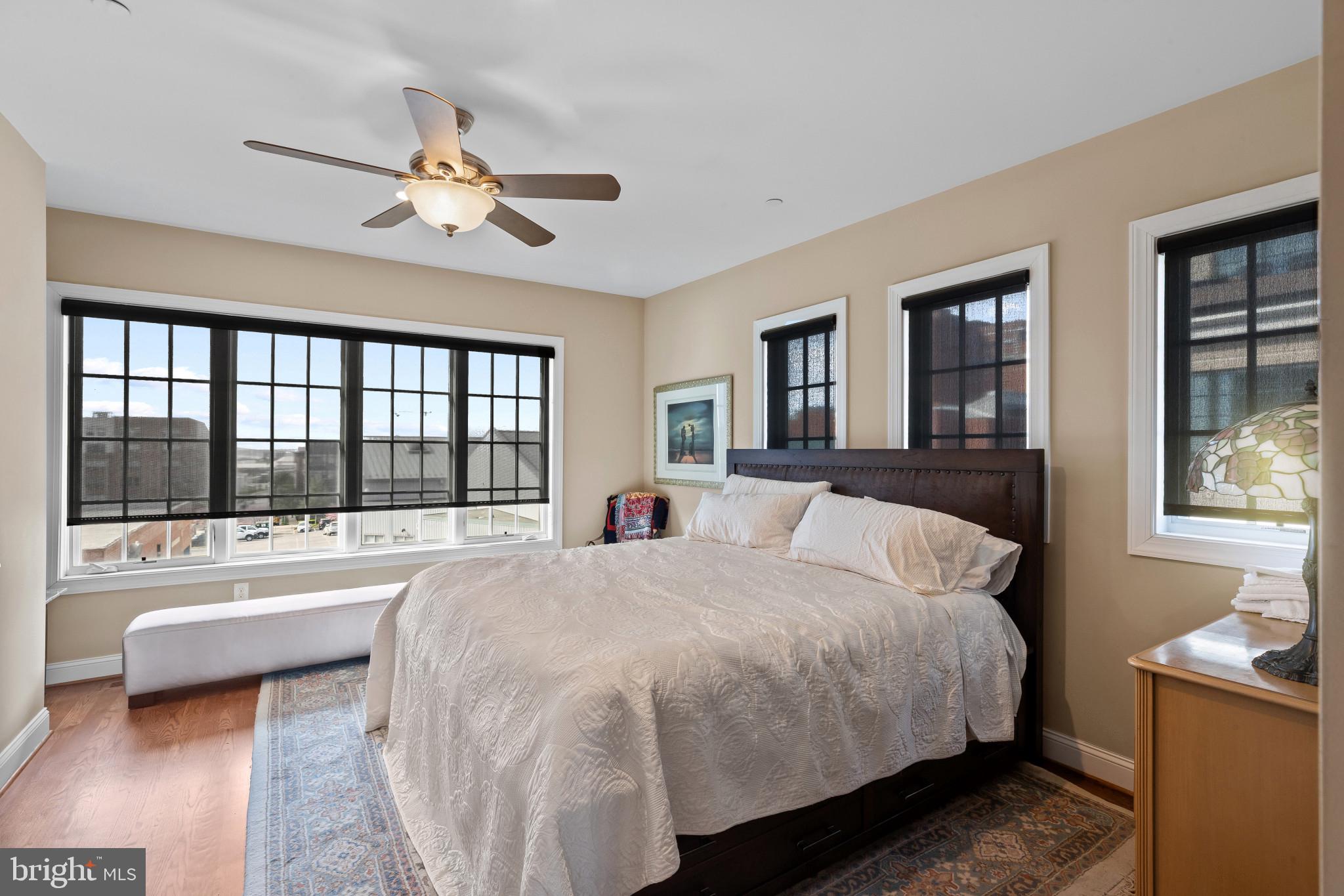 3800 Dillon Street Baltimore, MD 21224 - Photo 18 of 34 a spacious bedroom with a large bed and a chandelier