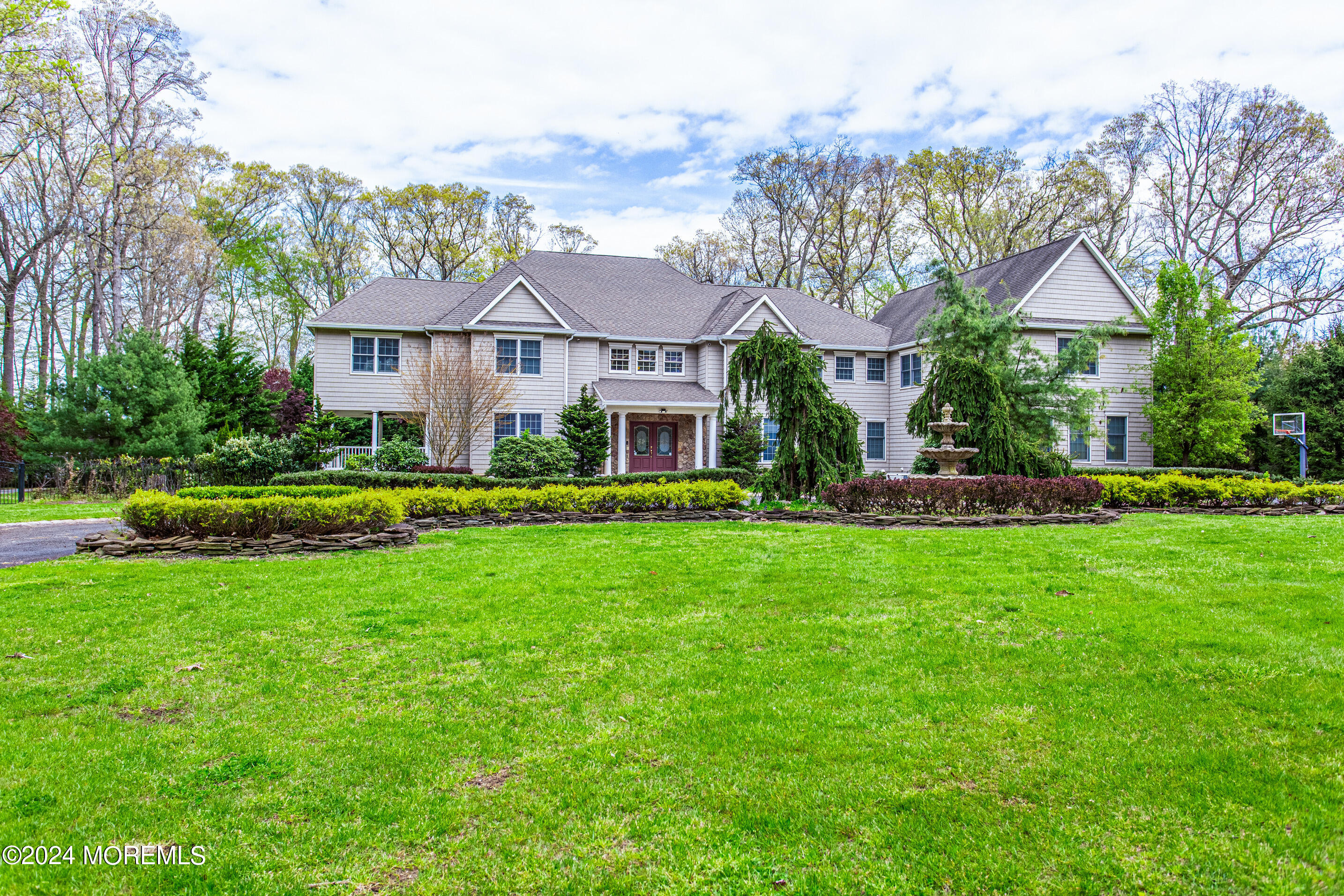 25 Woods End Road Colts Neck, NJ 07722 - Photo 1 of 76 a front view of a house with a yard
