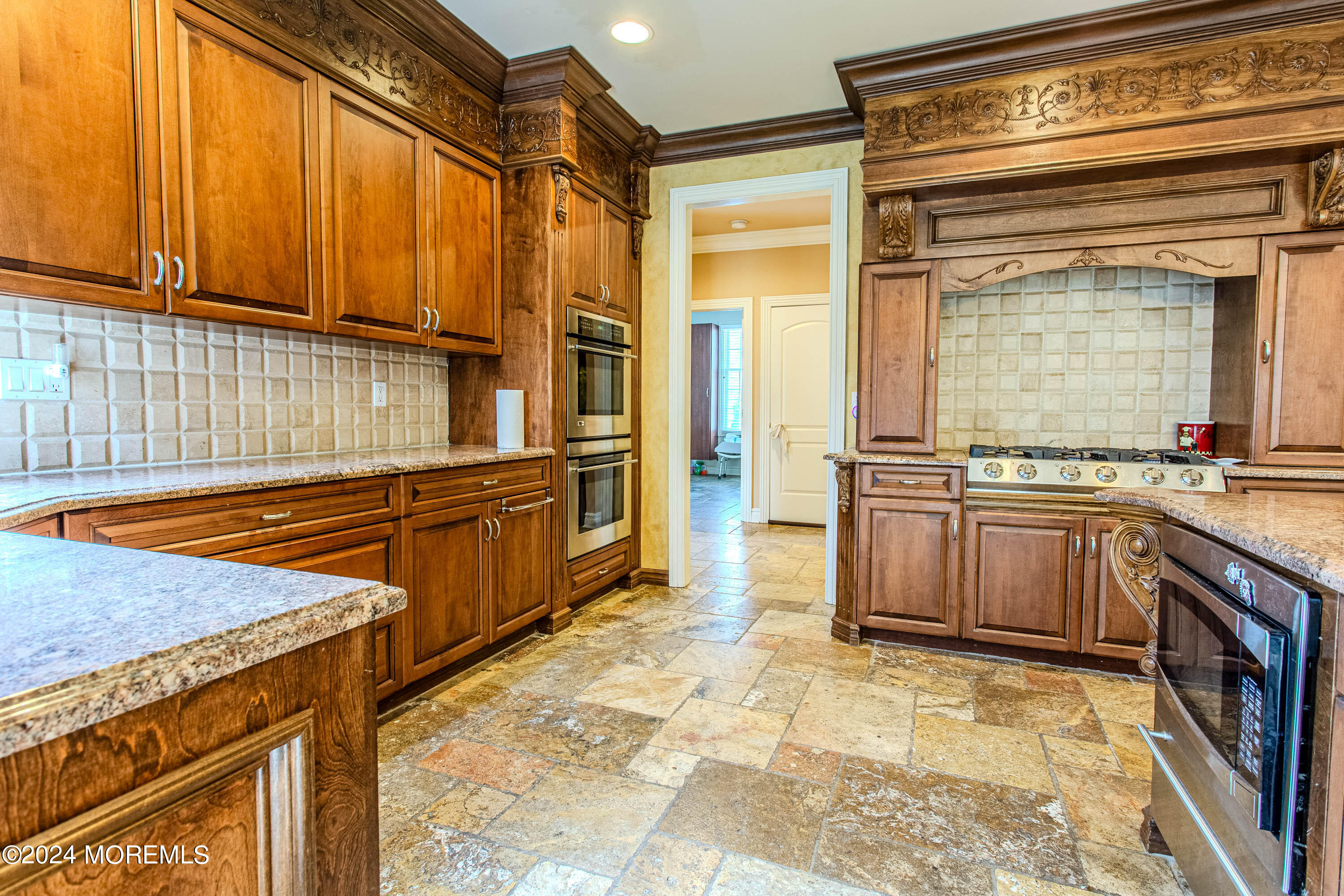 25 Woods End Road Colts Neck, NJ 07722 - Photo 19 of 76 a kitchen with stainless steel appliances granite countertop a stove a sink and a microwave