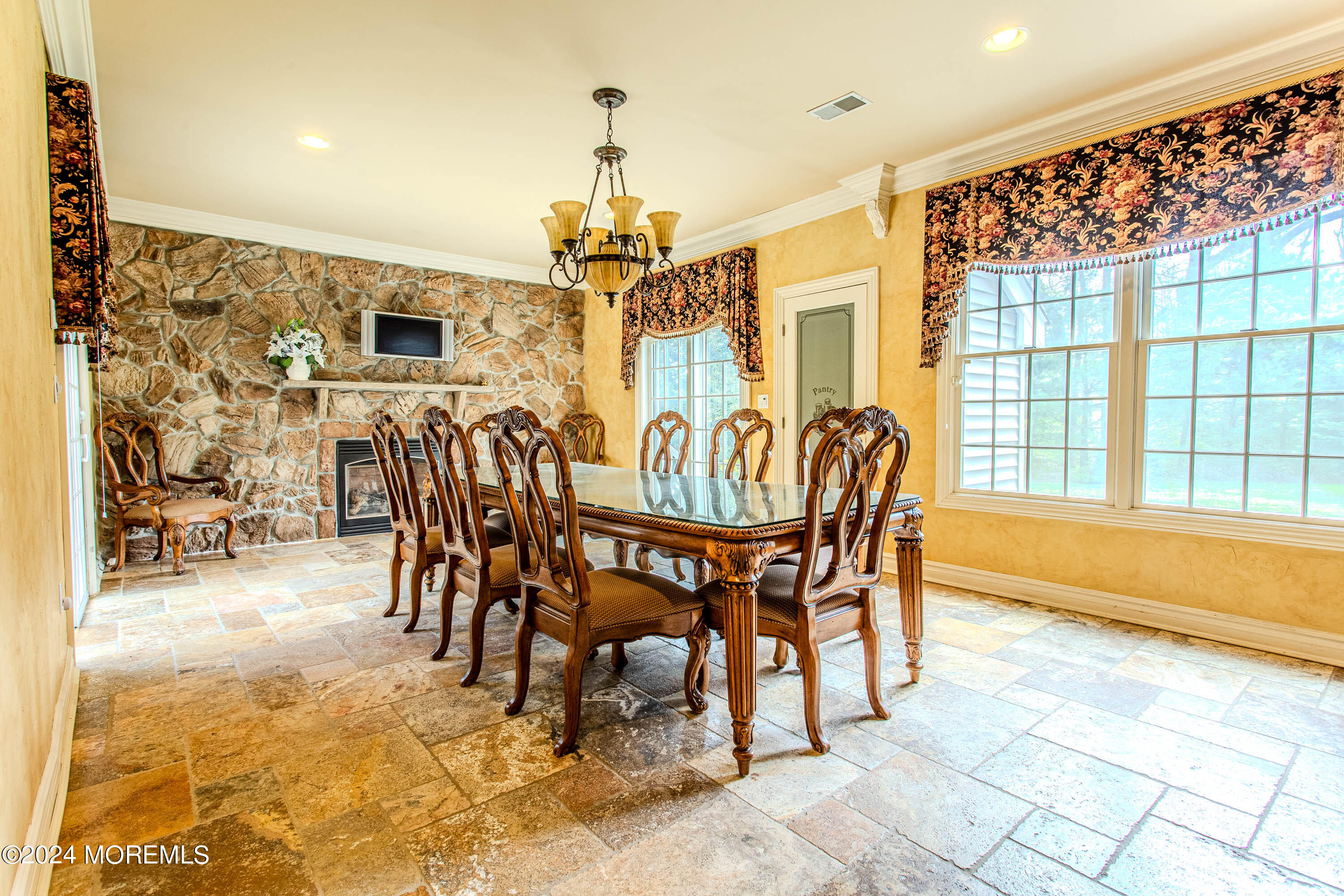 25 Woods End Road Colts Neck, NJ 07722 - Photo 22 of 76 a view of a dining room with furniture and a chandelier