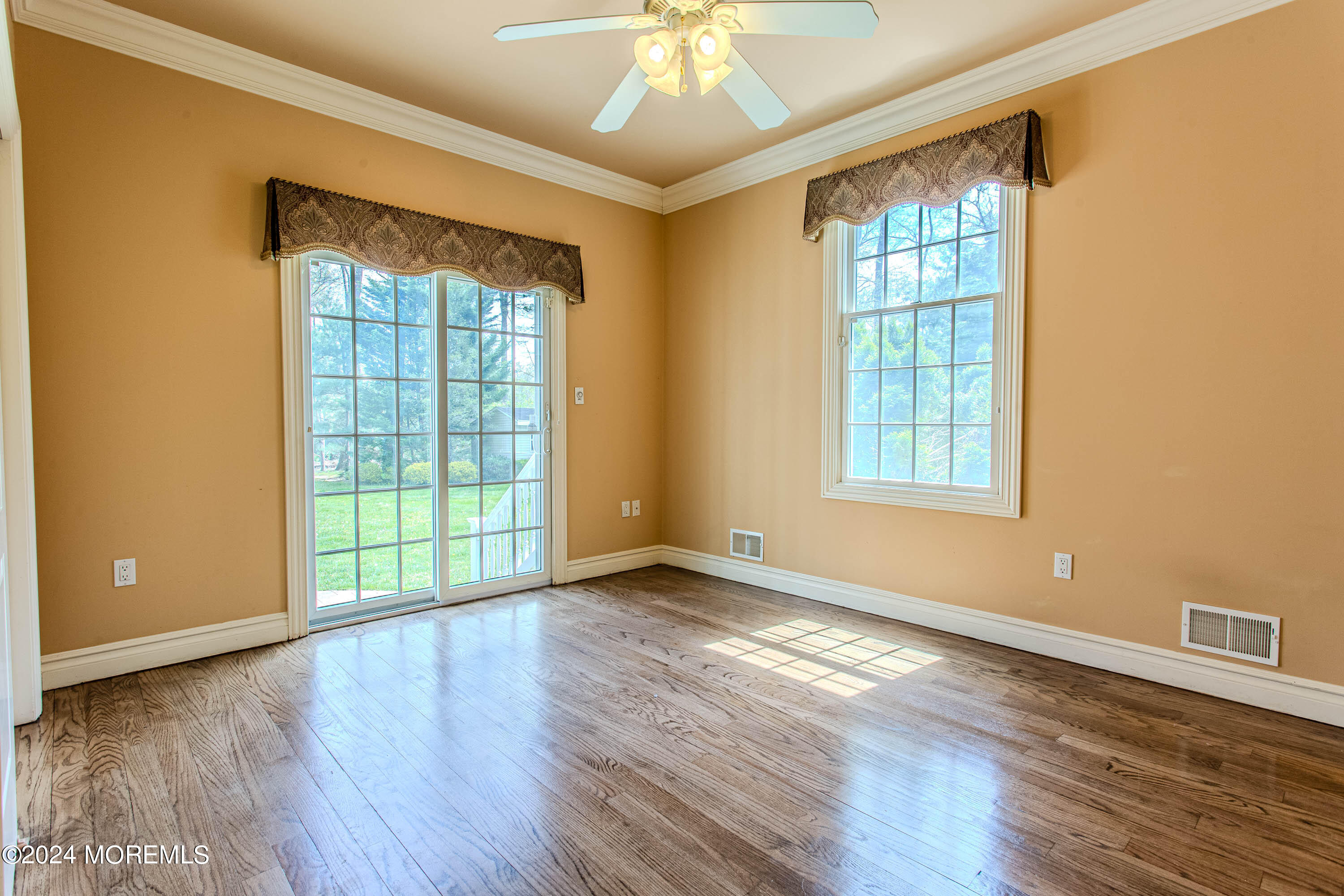 25 Woods End Road Colts Neck, NJ 07722 - Photo 26 of 76 an empty room with wooden floor and windows