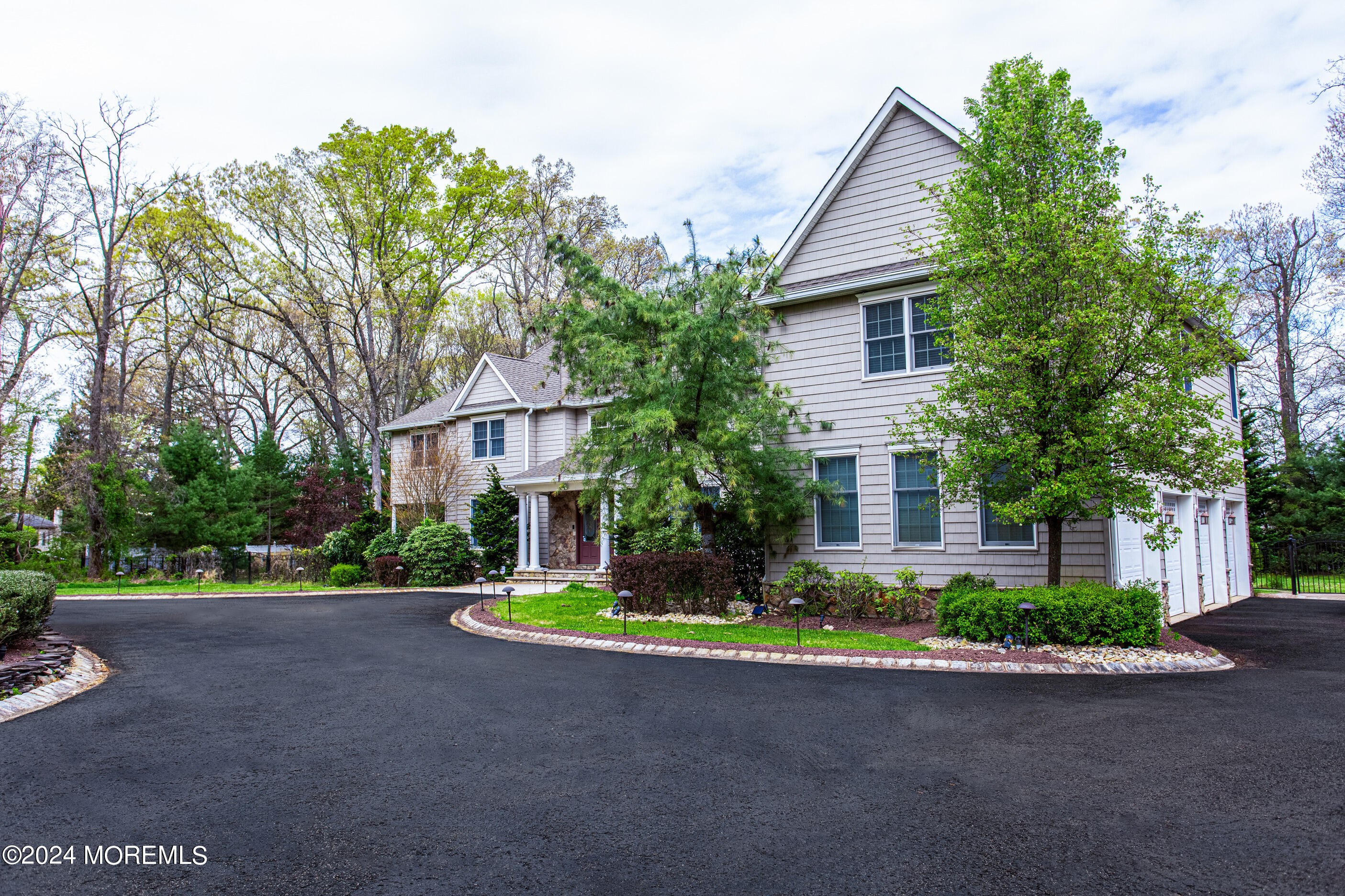 25 Woods End Road Colts Neck, NJ 07722 - Photo 3 of 76 a front view of a house with a yard and tree s