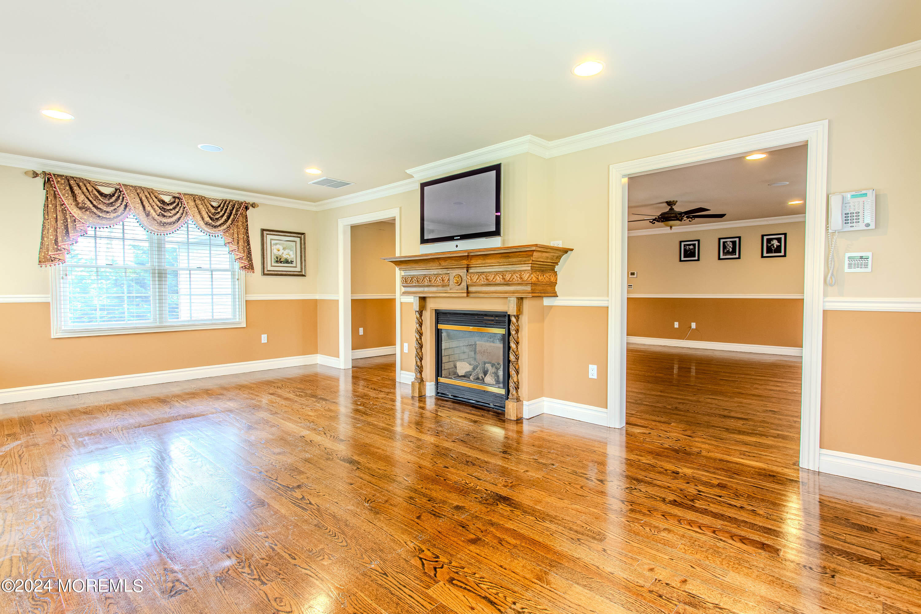 25 Woods End Road Colts Neck, NJ 07722 - Photo 36 of 76 a living room with furniture wooden floor and a flat screen tv