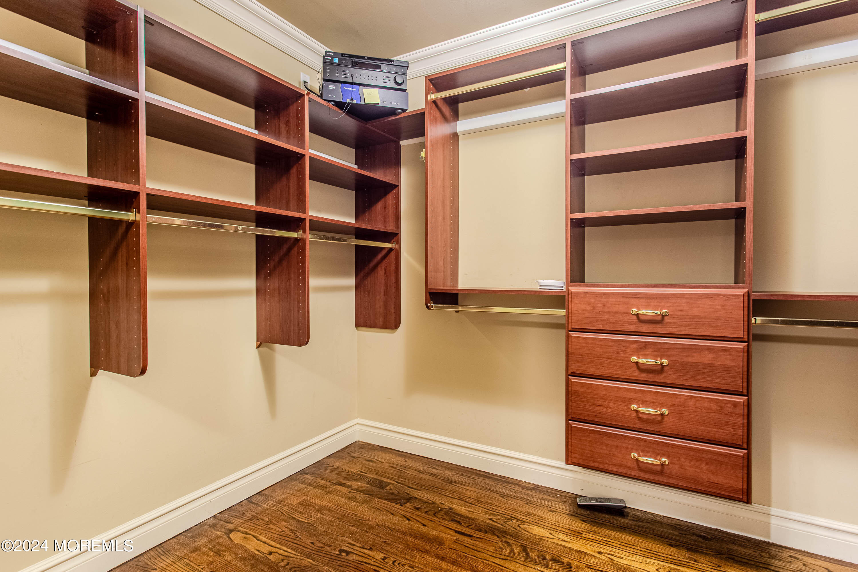 25 Woods End Road Colts Neck, NJ 07722 - Photo 38 of 76 a view of walk in closet with empty racks