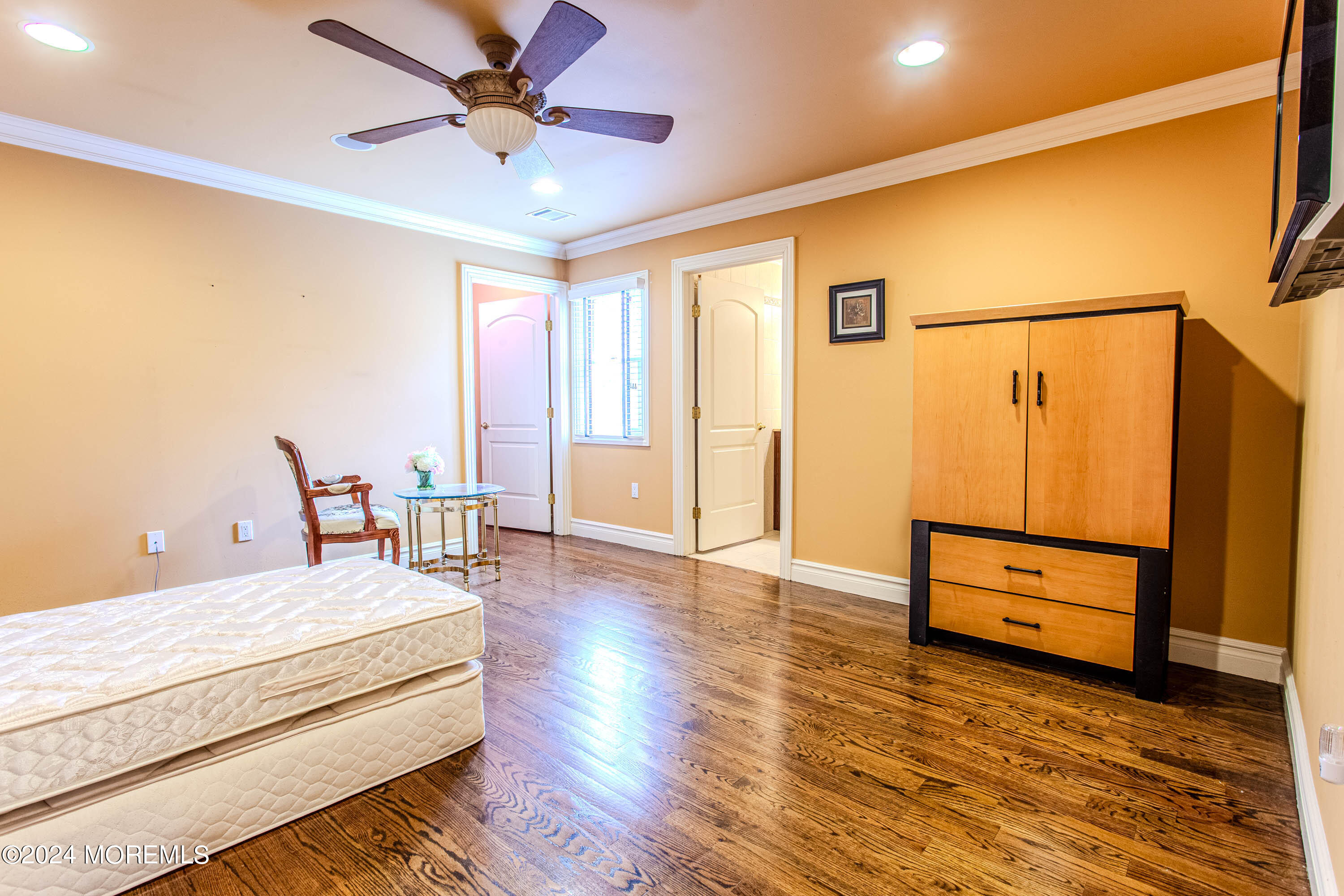 25 Woods End Road Colts Neck, NJ 07722 - Photo 45 of 76 a bedroom with a bed and wooden floor