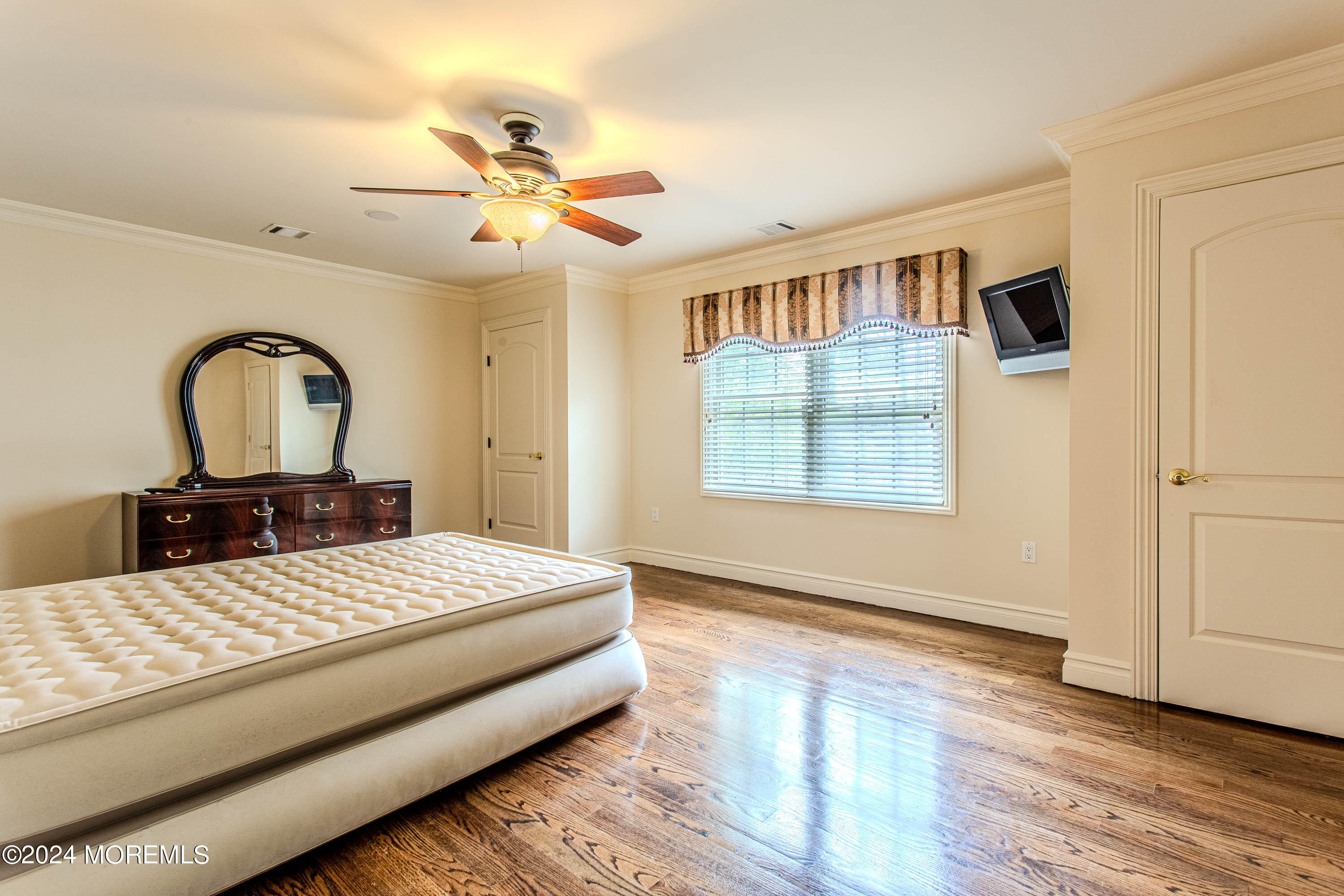 25 Woods End Road Colts Neck, NJ 07722 - Photo 57 of 76 a bedroom with a large bed and a window