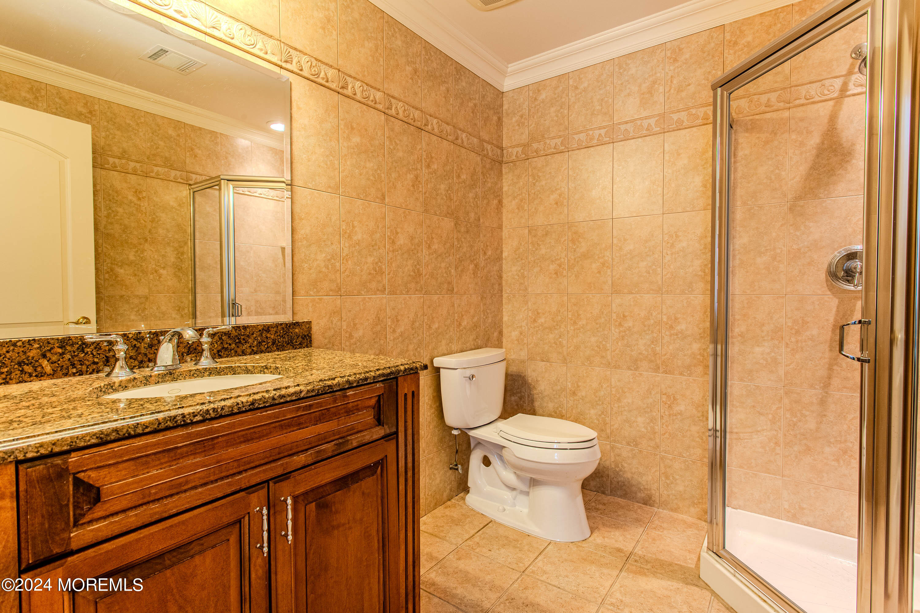 25 Woods End Road Colts Neck, NJ 07722 - Photo 59 of 76 a bathroom with a granite countertop sink a toilet and a shower