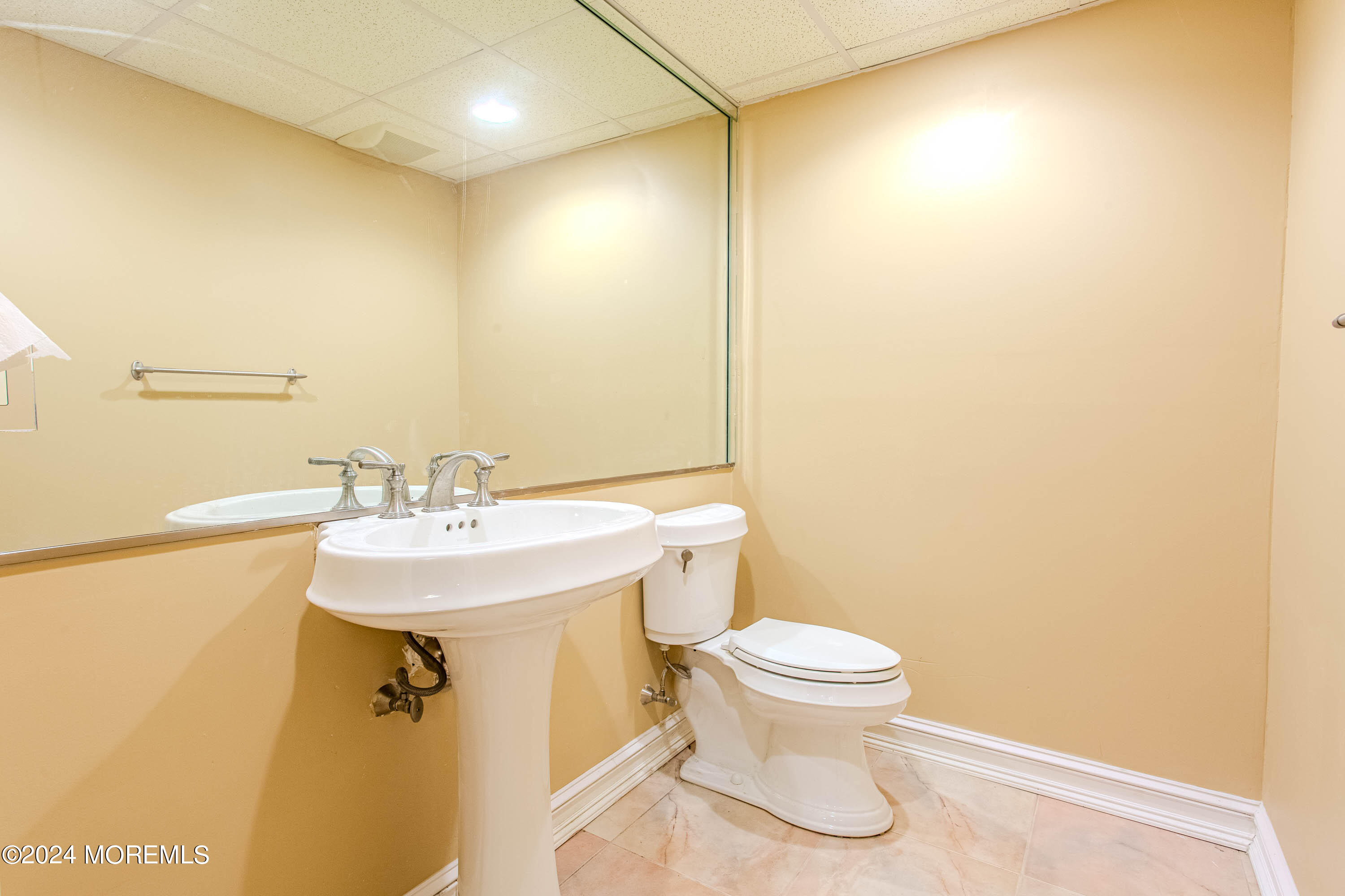25 Woods End Road Colts Neck, NJ 07722 - Photo 63 of 76 a bathroom with a sink a toilet and mirror