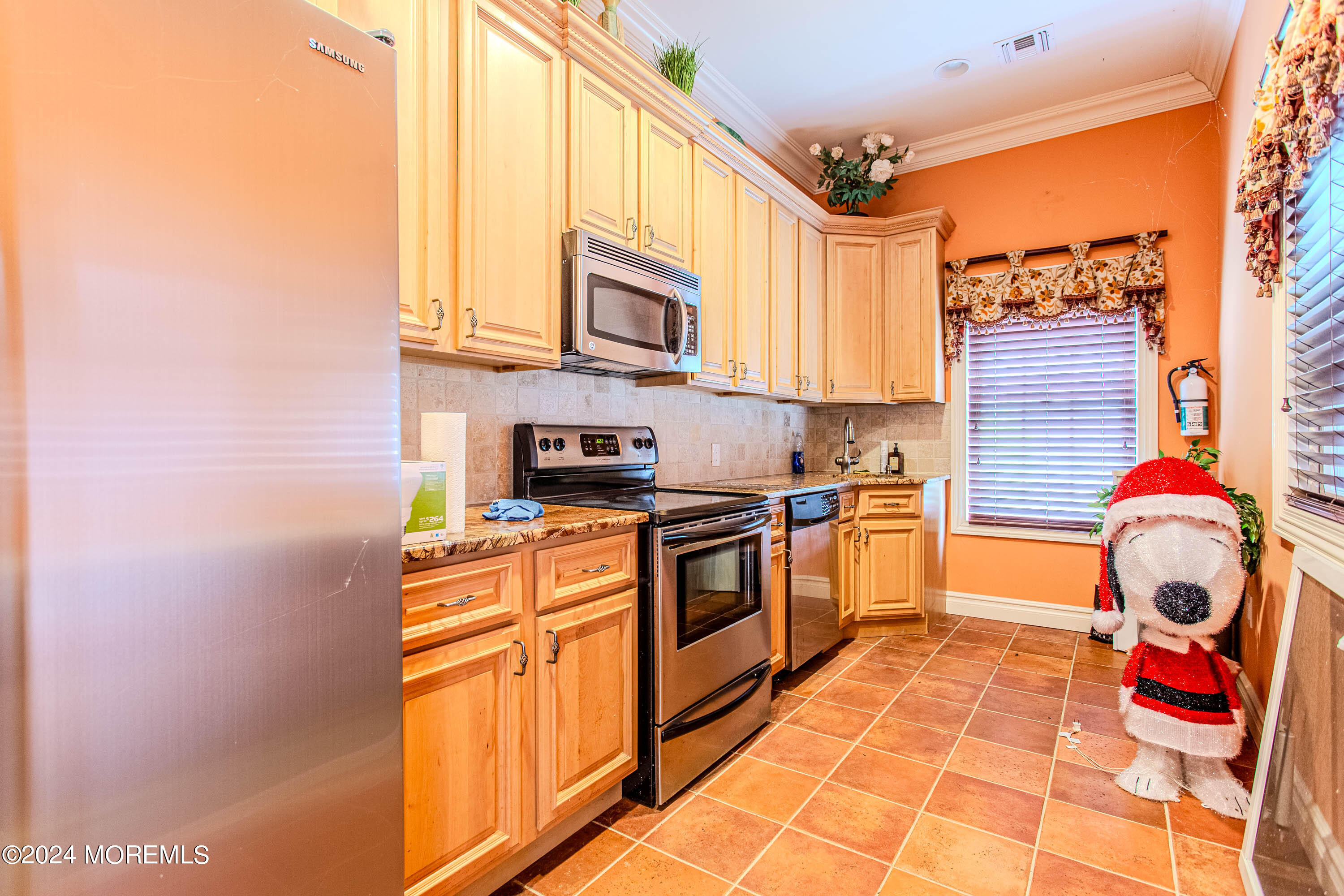 25 Woods End Road Colts Neck, NJ 07722 - Photo 66 of 76 a kitchen with stainless steel appliances granite countertop a stove a sink and a microwave