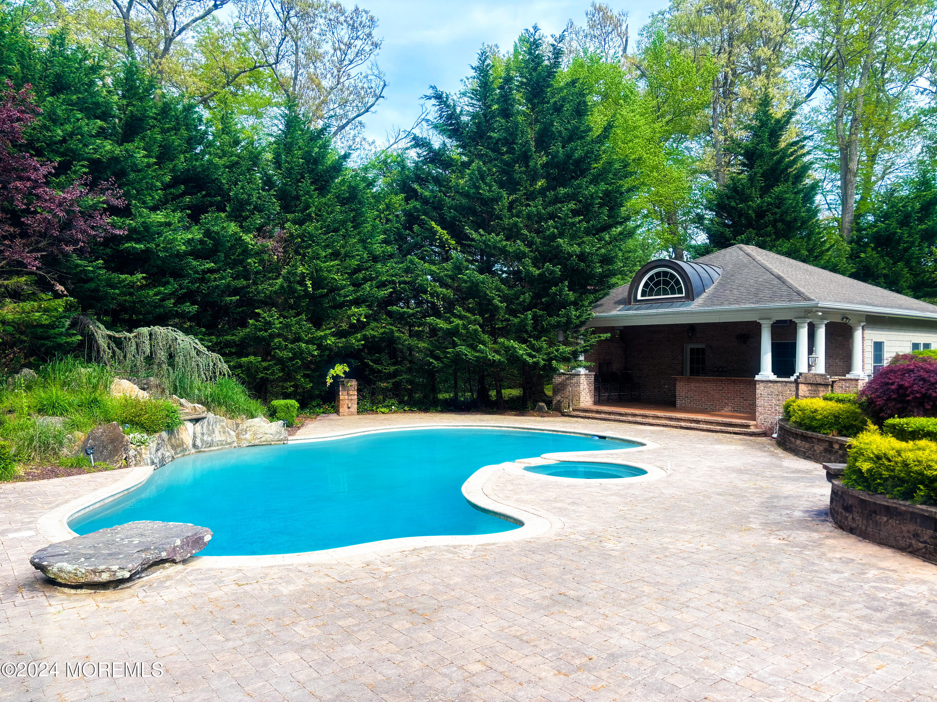 25 Woods End Road Colts Neck, NJ 07722 - Photo 71 of 76 a front view of a house with a yard and garage