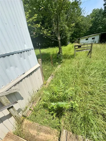 a backyard of a house with a yard and outdoor seating